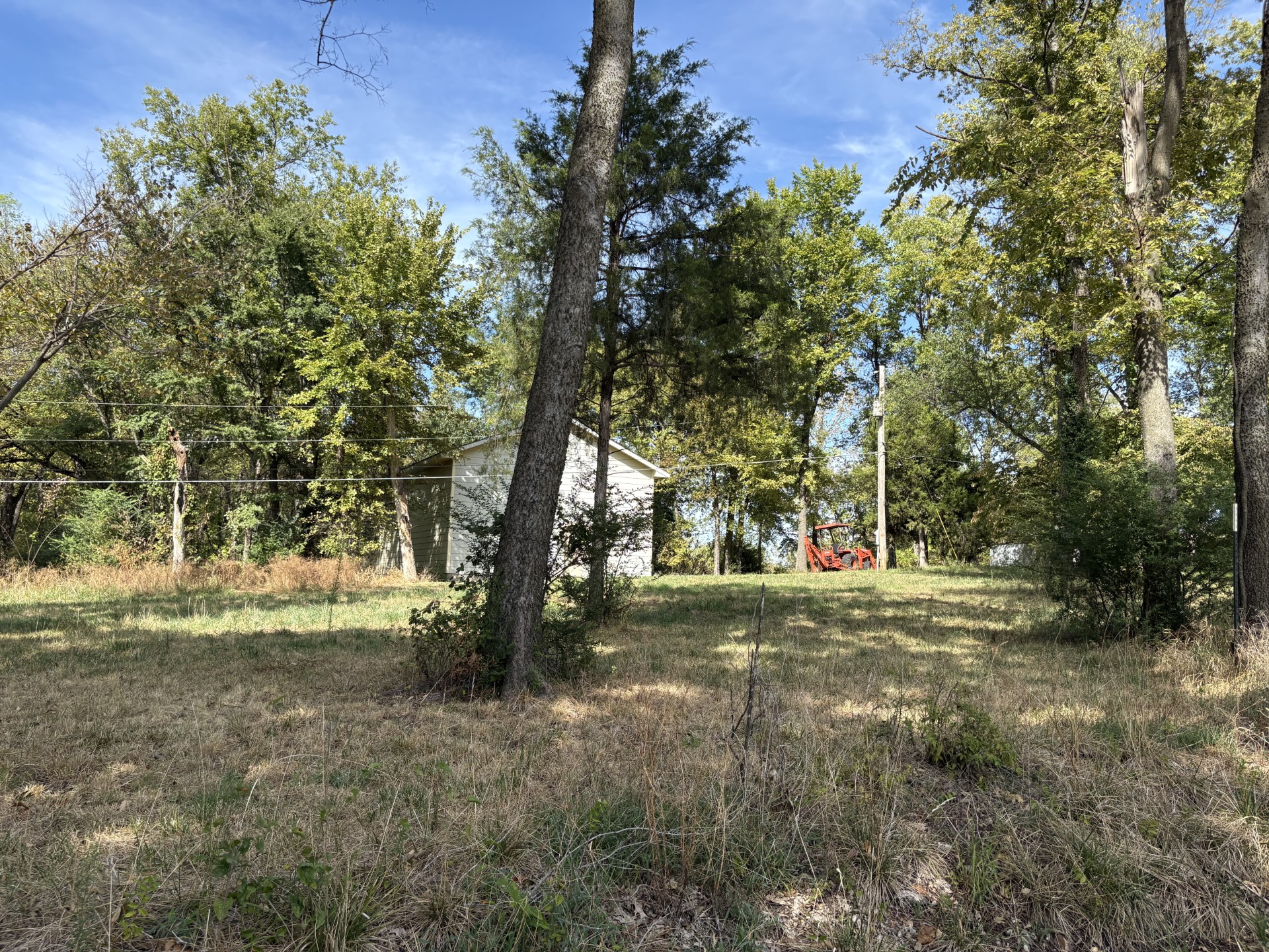 East Parker Road Afton, OK 74331 - Photo 5 of 6 Partially wooded parcel with a gravel road, natural ground cover, and mature trees