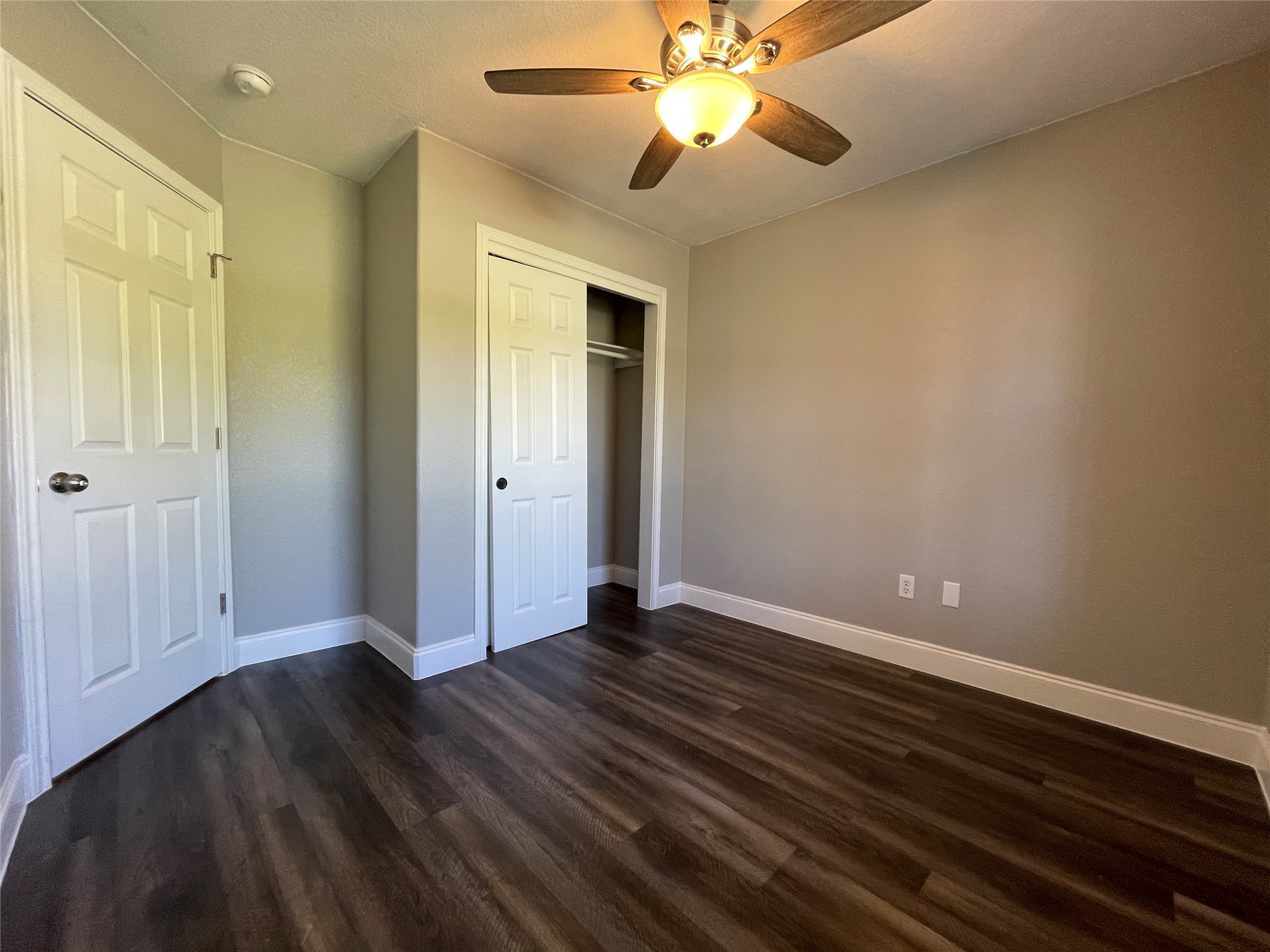2004 Maple Street Georgetown, TX 78626 - Photo 13 of 31 Bedroom featuring wood-finish flooring, neutral wall paint, and a ceiling fan with integrated lighting