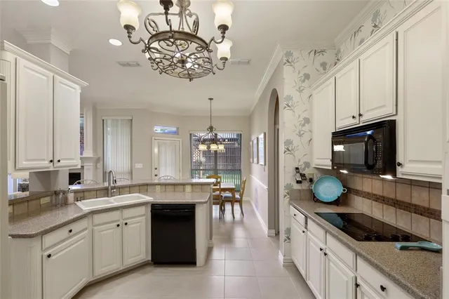 a kitchen with a sink stove and cabinets