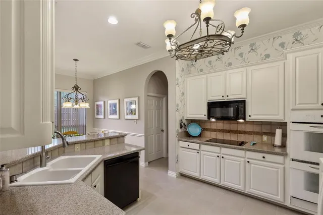 a spacious bathroom with a granite countertop sink a mirror and a bathtub