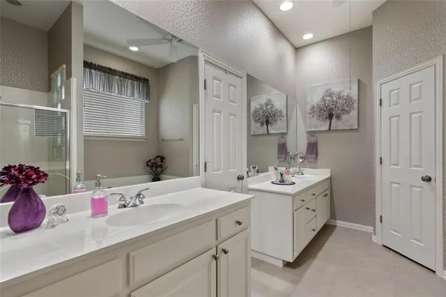 a bathroom with a sink double vanity and a shower