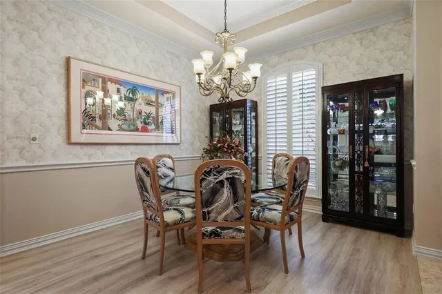 a view of a dining room with furniture wooden floor and chandelier