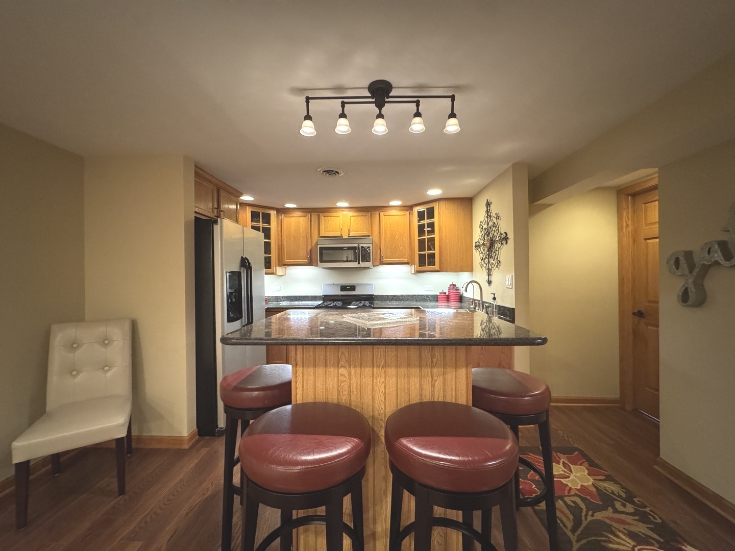 2041 Bluff Road South Kankakee, IL 60901 - Photo 23 of 39 a kitchen with stainless steel appliances kitchen island granite countertop furniture and a refrigerator