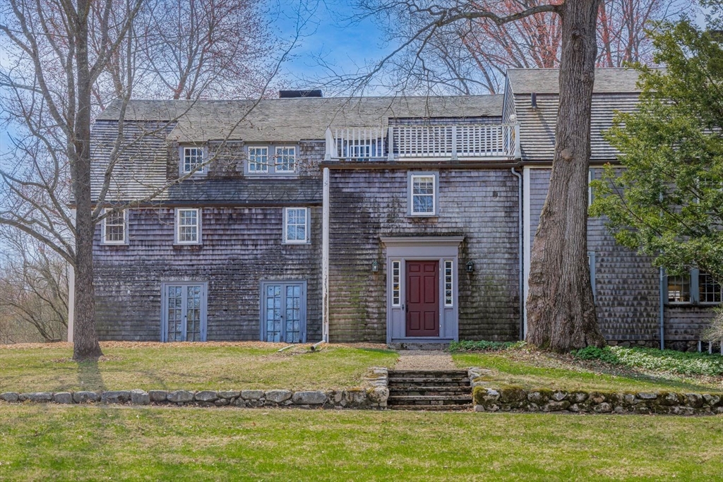 9 Maple Street Wenham, MA 01984 - Photo 15 of 42 a brick building with a small yard in front of it
