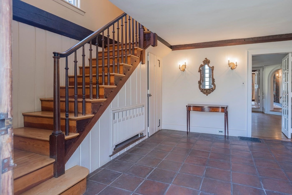 9 Maple Street Wenham, MA 01984 - Photo 16 of 42 a view of staircase with lots of frames on wall and a window