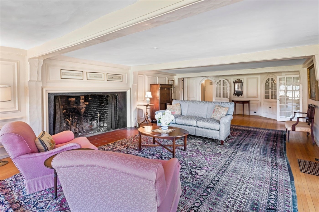 9 Maple Street Wenham, MA 01984 - Photo 20 of 42 a living room with furniture fireplace and a table