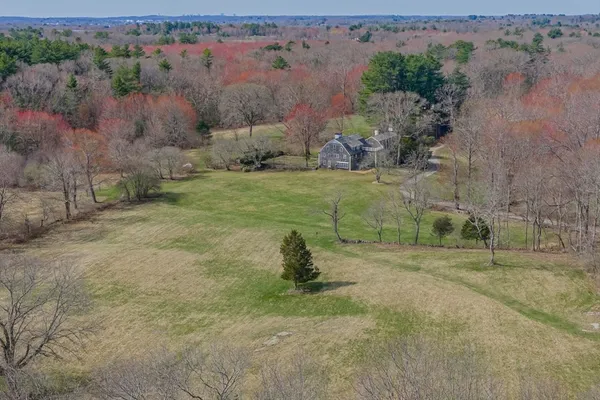an aerial view of a house with a yard