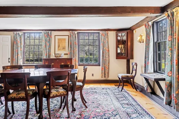 a view of a dining room with furniture and chandelier