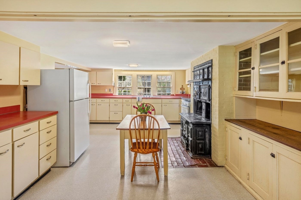 9 Maple Street Wenham, MA 01984 - Photo 25 of 42 a kitchen with stainless steel appliances granite countertop a refrigerator and a stove top oven