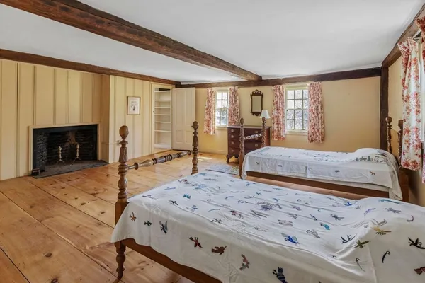 a spacious bedroom with a large bed and a fireplace