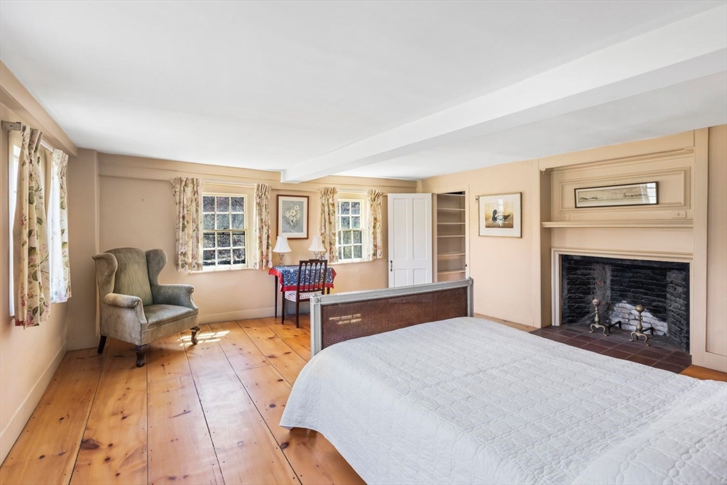 9 Maple Street Wenham, MA 01984 - Photo 32 of 42 a spacious bedroom with a large bed and a fireplace