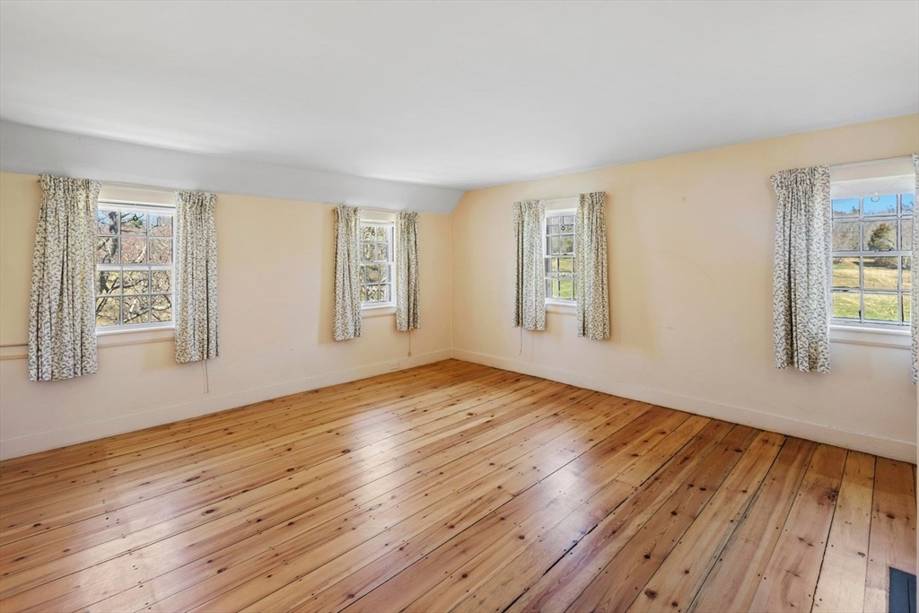 9 Maple Street Wenham, MA 01984 - Photo 34 of 42 a view of an empty room with window and wooden floor