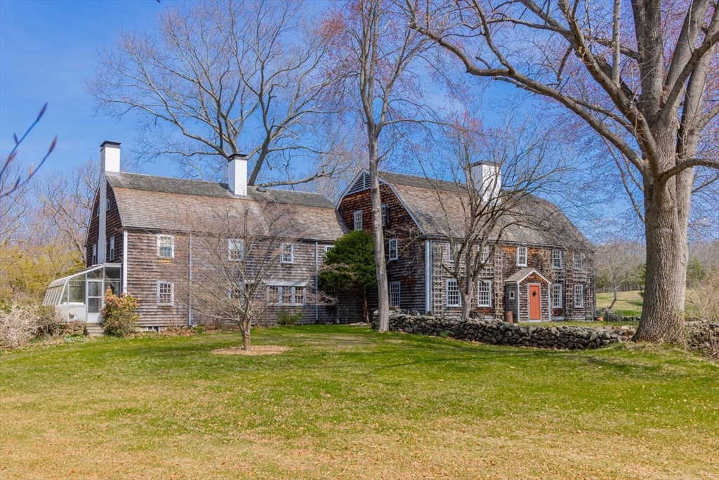 9 Maple Street Wenham, MA 01984 - Photo 9 of 42 a large brick building with a big yard and large trees