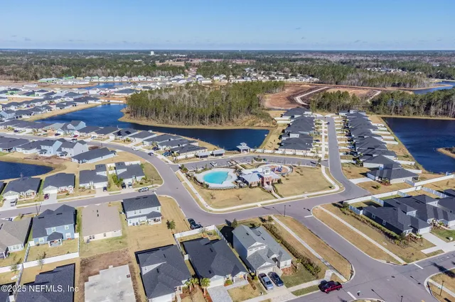 an aerial view of a city with ocean view in back