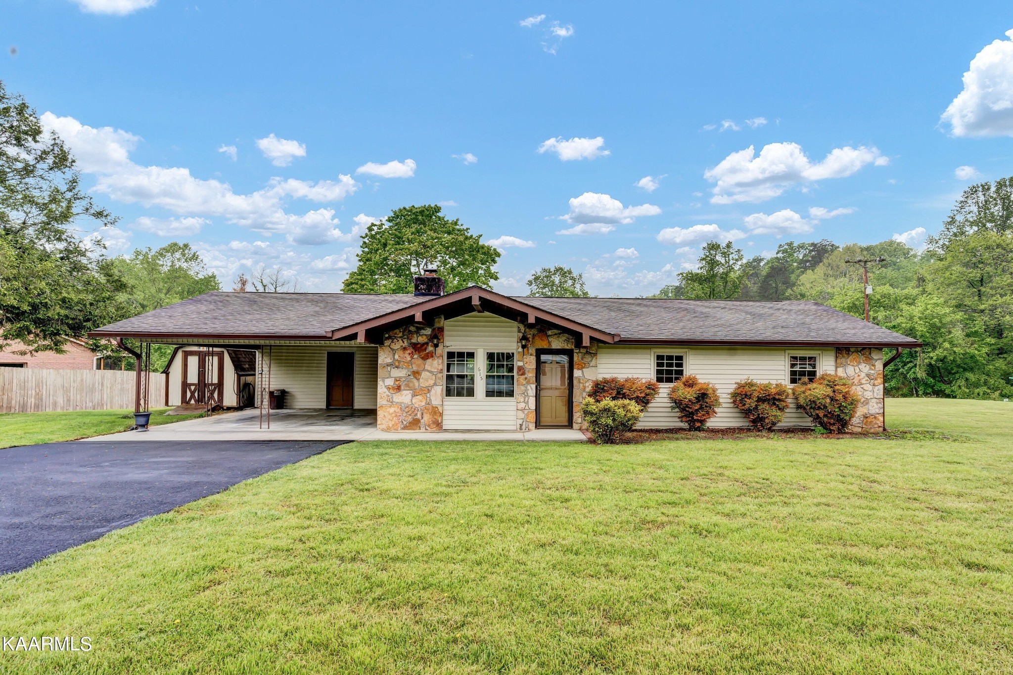 a view of a house with a yard and potted plants