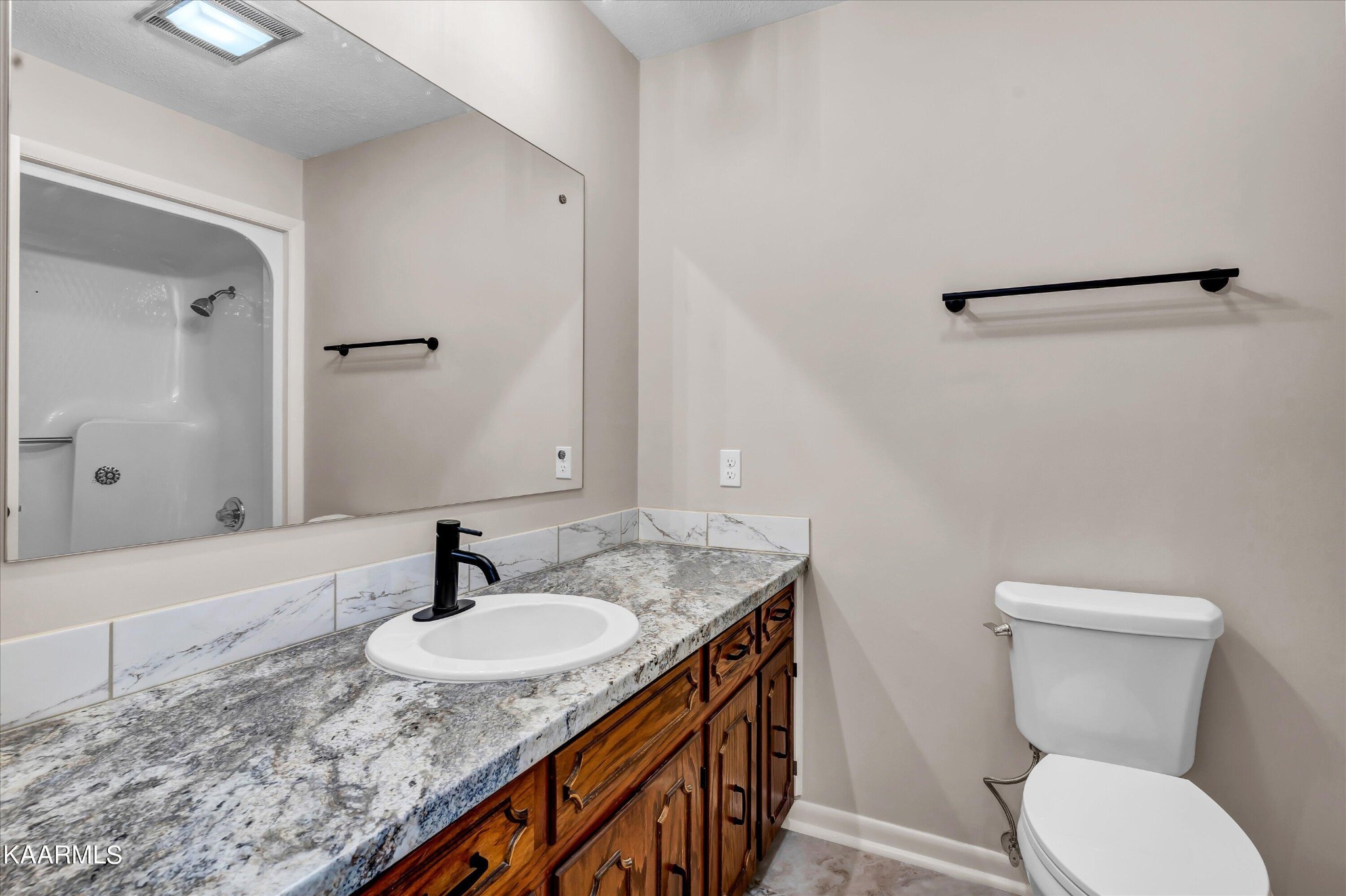 615 Kings Row Sevierville, TN 37863 - Photo 18 of 26 a bathroom with a granite countertop sink toilet and shower