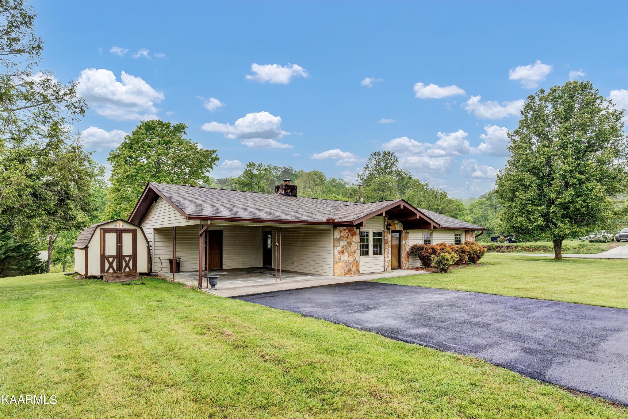 615 Kings Row Sevierville, TN 37863 - Photo 2 of 26 a front view of a house with a garden and trees