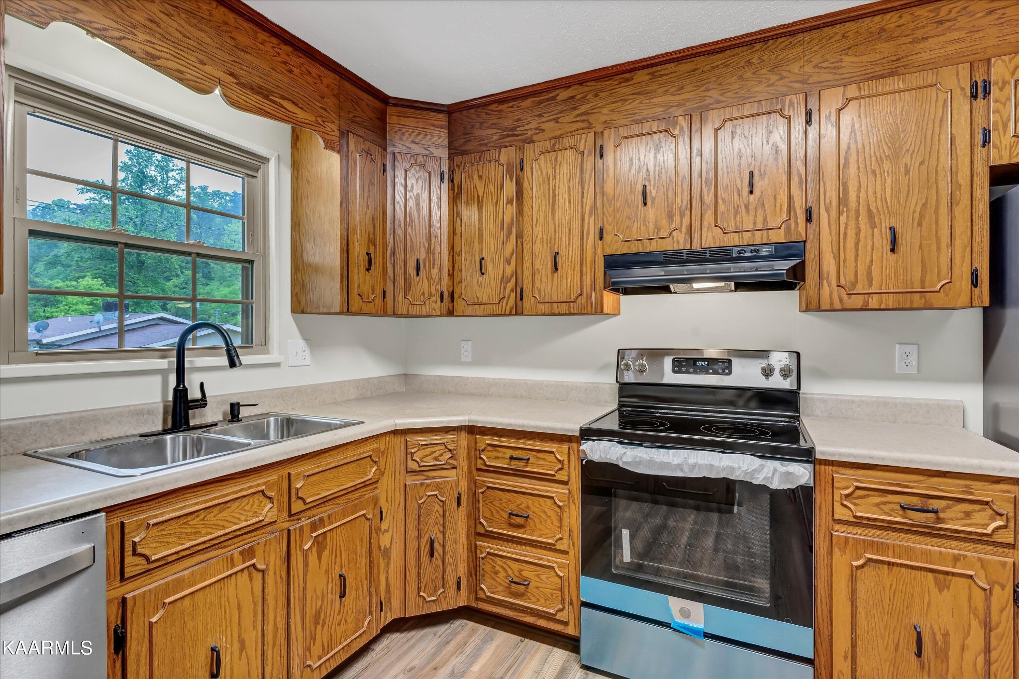 615 Kings Row Sevierville, TN 37863 - Photo 9 of 26 a kitchen with stainless steel appliances granite countertop a stove a sink and a microwave