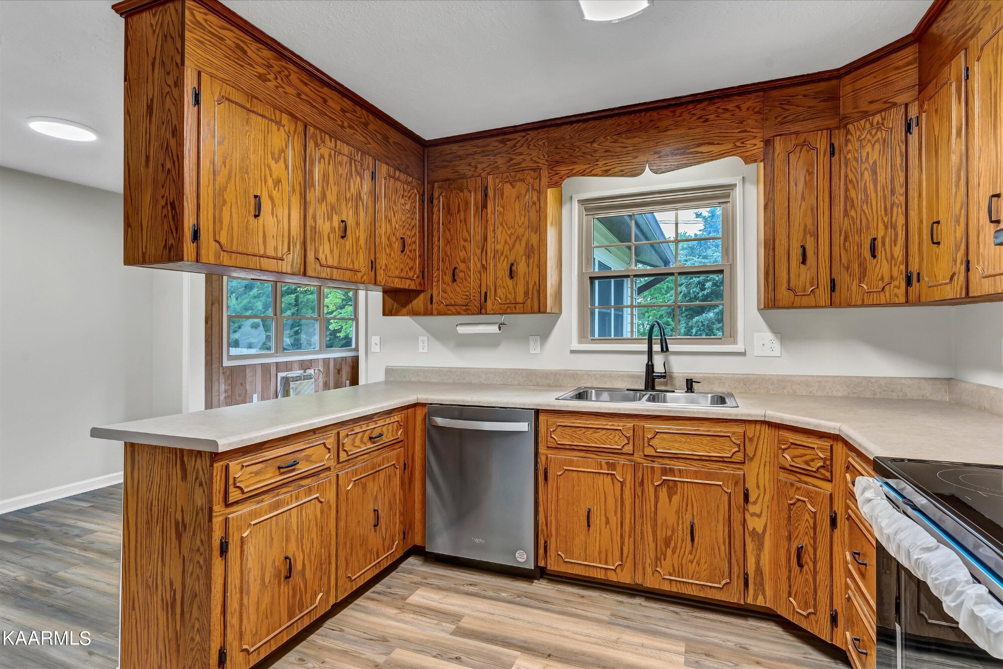 615 Kings Row Sevierville, TN 37863 - Photo 10 of 26 a kitchen with stainless steel appliances granite countertop wooden cabinets a sink and dishwasher a oven with wooden floor