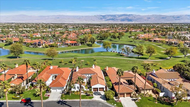 an aerial view of residential building with outdoor space lake view and mountain view in back
