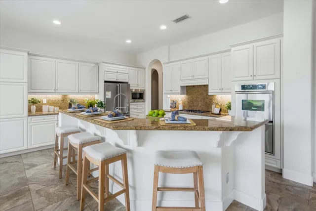 a dining room with furniture a chandelier and a rug