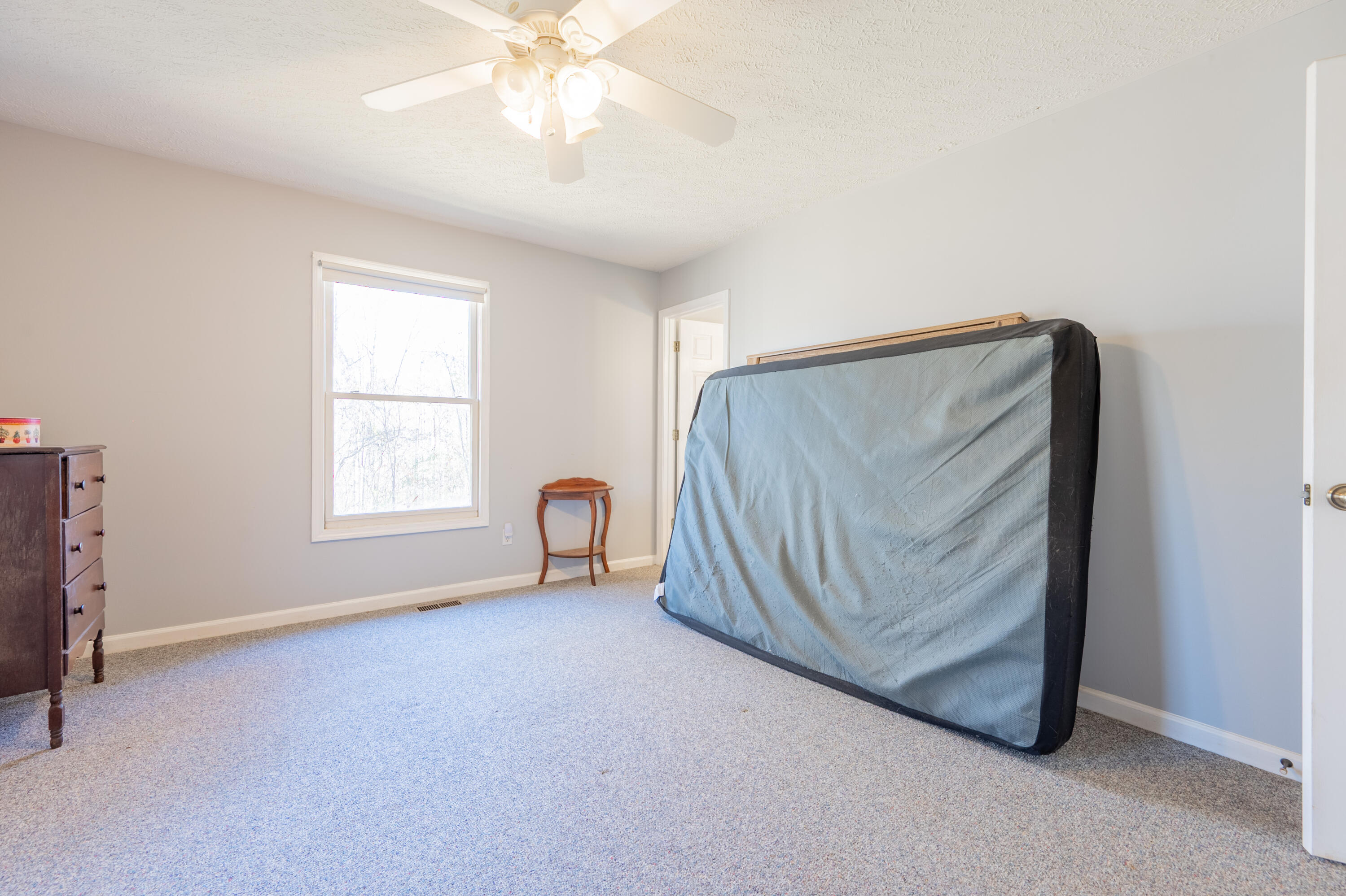1126 Duncans Chapel Road Northwest Willis, VA 24380 - Photo 33 of 74 an empty room with windows and fan