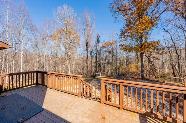 a view of a wooden deck with trees