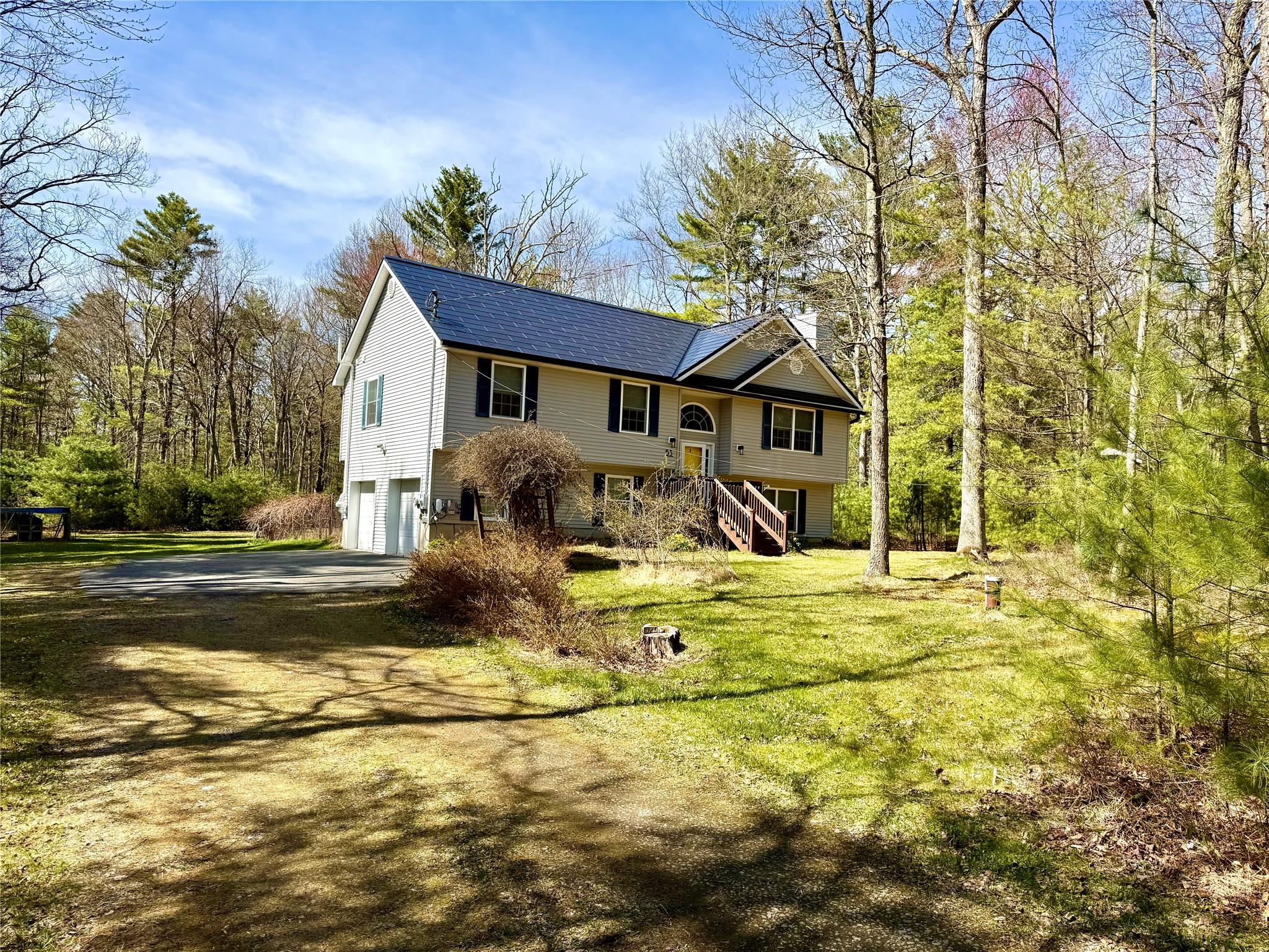 a view of a house with backyard and sitting area
