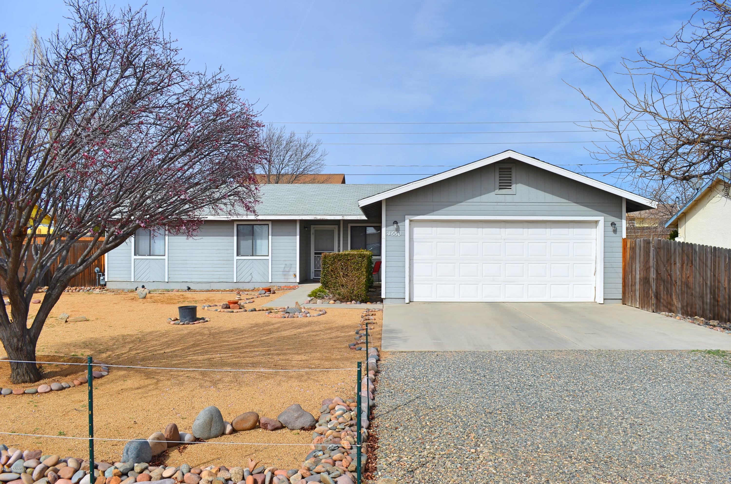 a view of a house with snow on the side of road