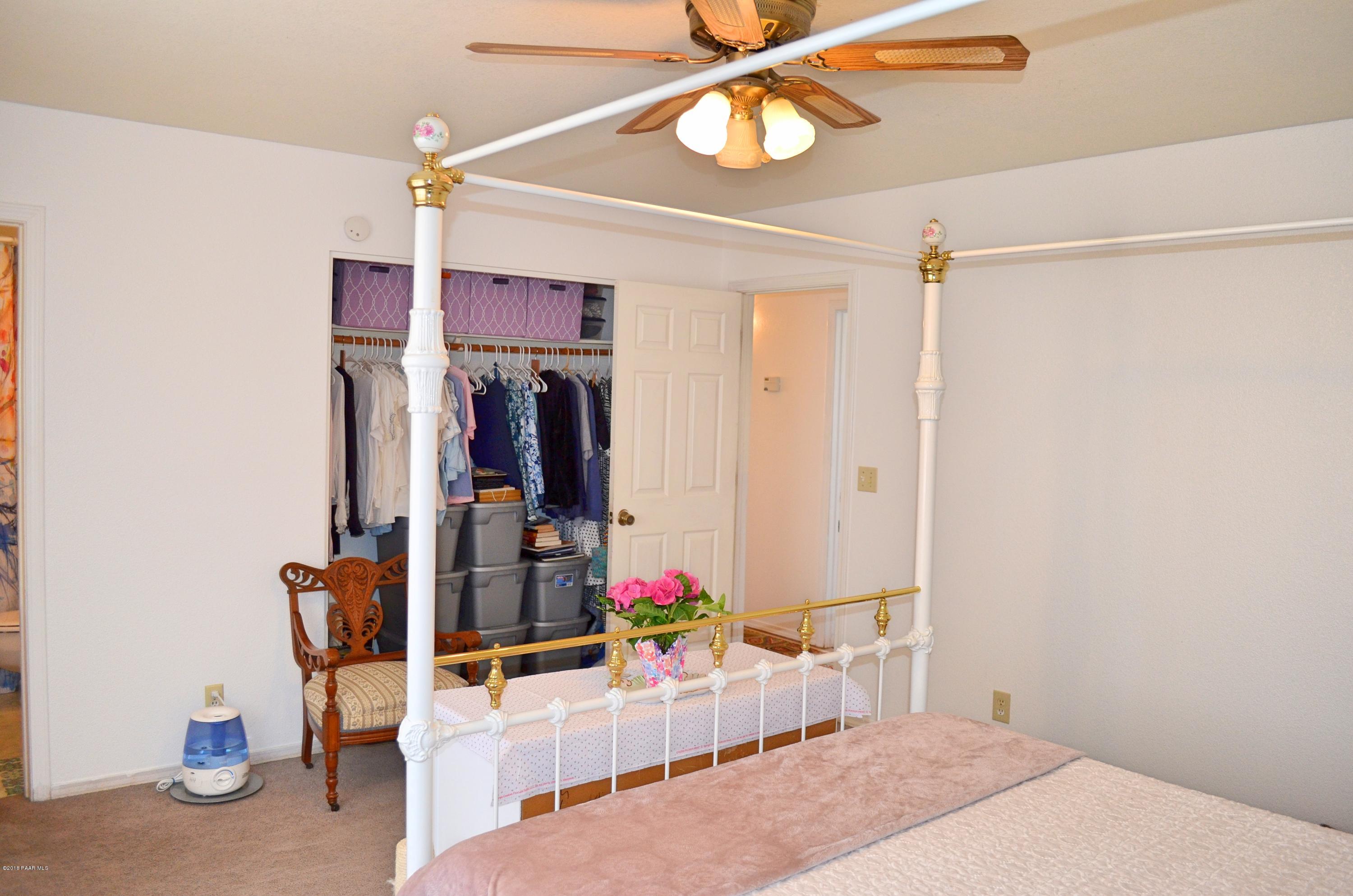 4660 North Miner Road Prescott Valley, AZ 86314 - Photo 11 of 20 a bedroom with a bed and a chandelier
