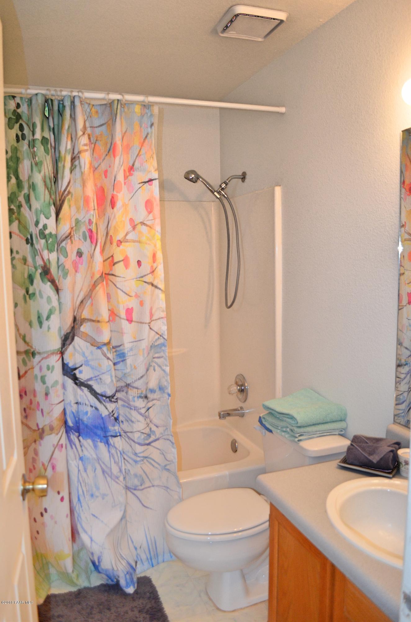 4660 North Miner Road Prescott Valley, AZ 86314 - Photo 12 of 20 a bathroom with a granite countertop sink toilet and shower