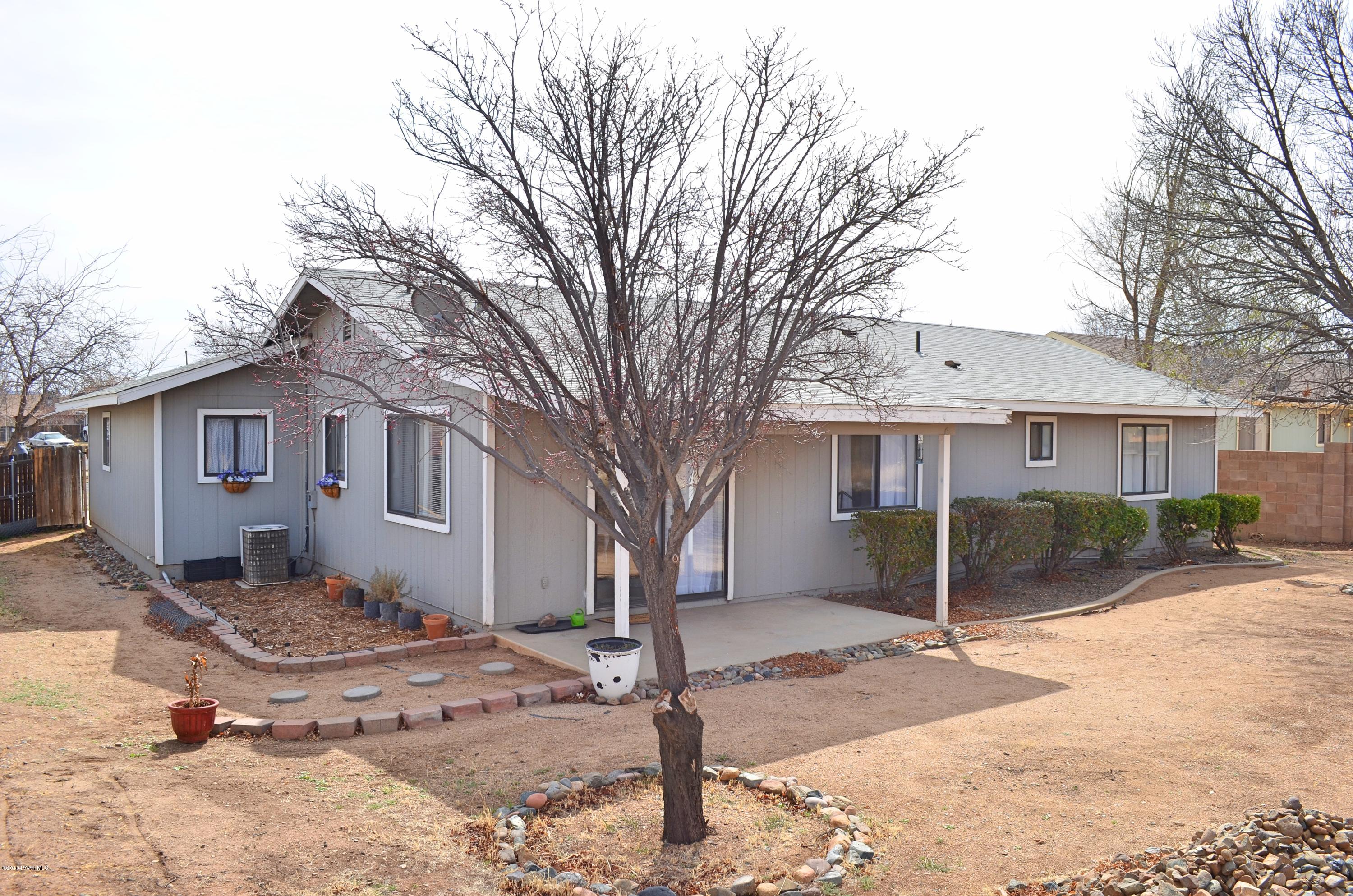 4660 North Miner Road Prescott Valley, AZ 86314 - Photo 19 of 20 a front view of a house with a yard and garage