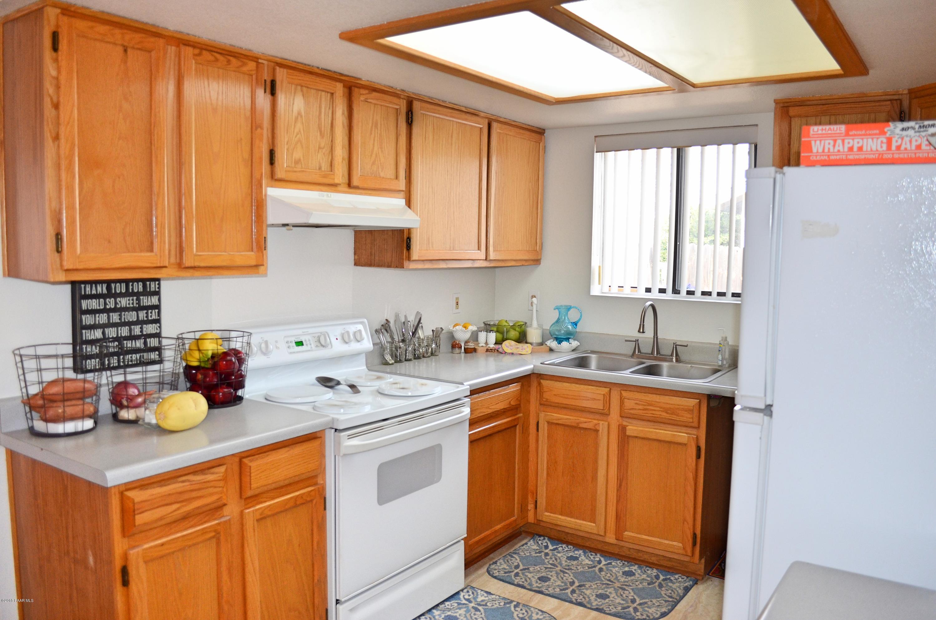 4660 North Miner Road Prescott Valley, AZ 86314 - Photo 9 of 20 a kitchen with a sink a stove and cabinets