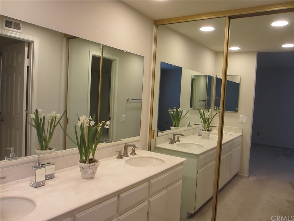12 Brookdale Irvine, CA 92604 - Photo 11 of 28 a bathroom with double vanity and a mirror