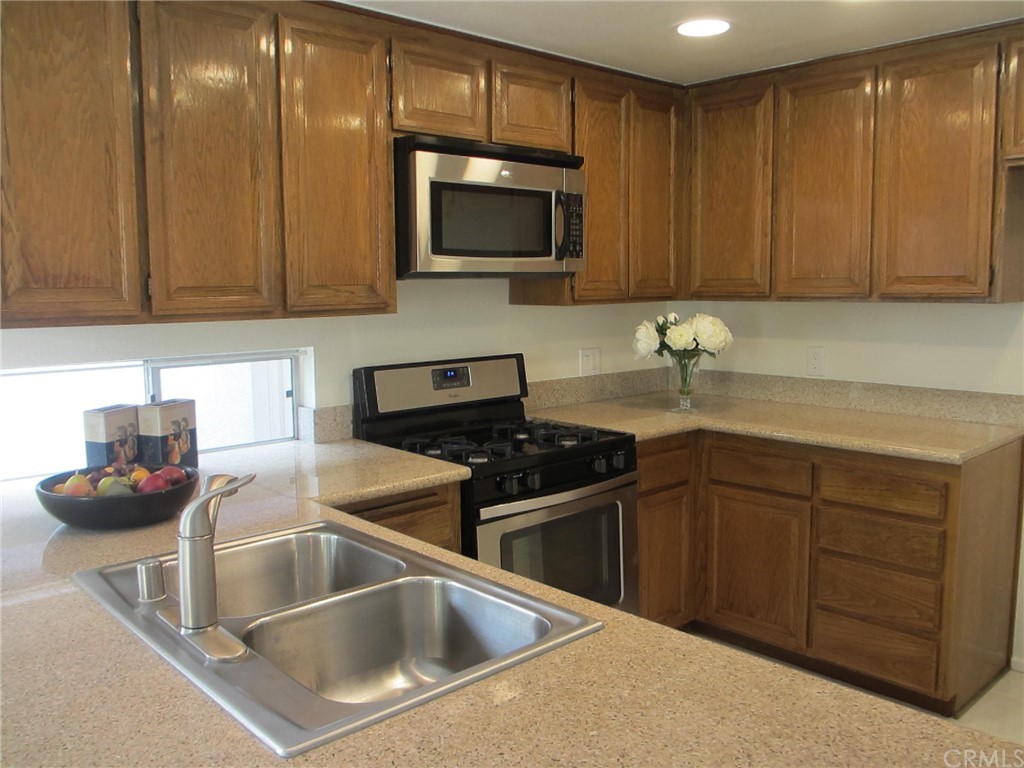 12 Brookdale Irvine, CA 92604 - Photo 2 of 28 a kitchen with a sink cabinets and stainless steel appliances