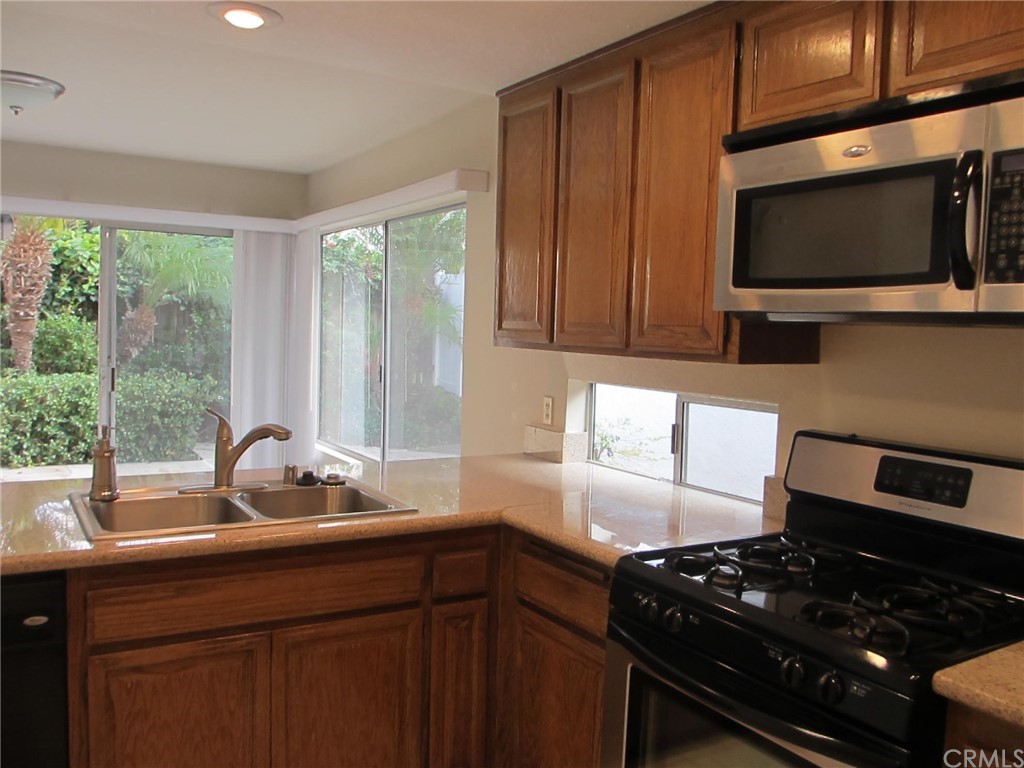 12 Brookdale Irvine, CA 92604 - Photo 4 of 28 a kitchen with a sink stove and microwave