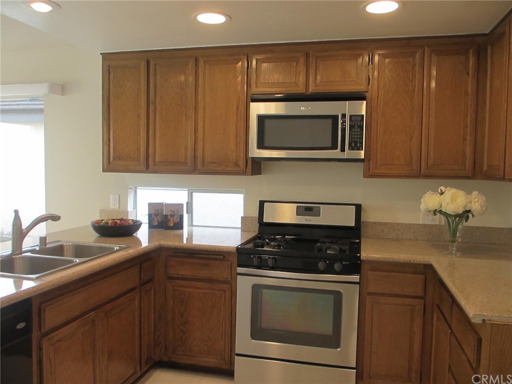 12 Brookdale Irvine, CA 92604 - Photo 5 of 28 a kitchen with stainless steel appliances granite countertop a sink stove and microwave
