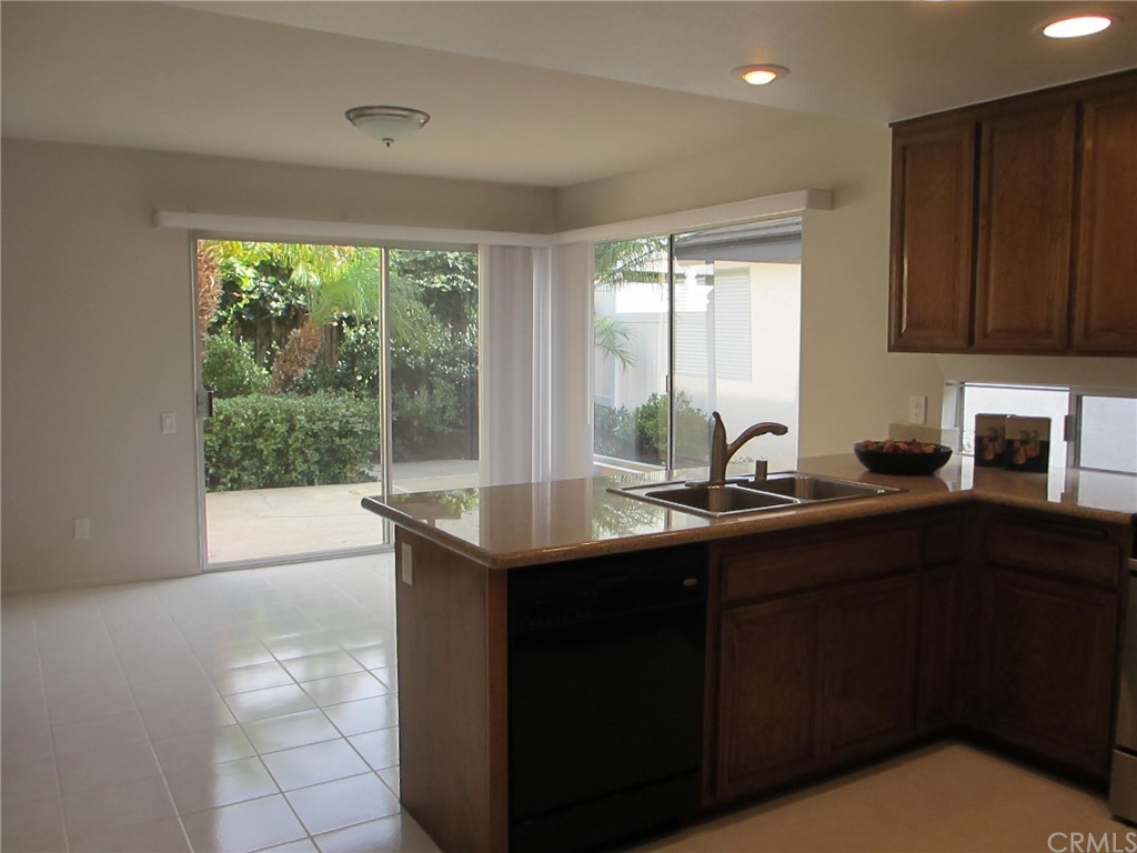 12 Brookdale Irvine, CA 92604 - Photo 6 of 28 a kitchen with a sink a window and cabinets