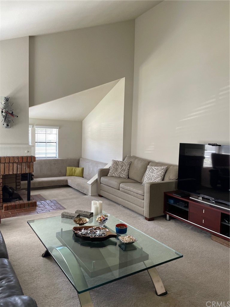 12 Brookdale Irvine, CA 92604 - Photo 8 of 28 a living room with furniture and a flat screen tv
