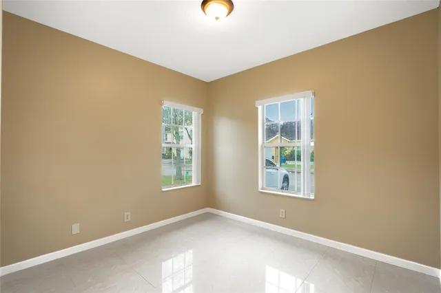 a view of an empty room with windows