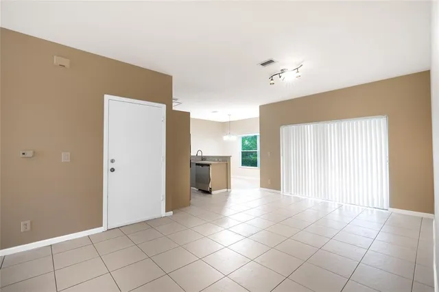 a view of a kitchen with a sink and a cabinet an empty room