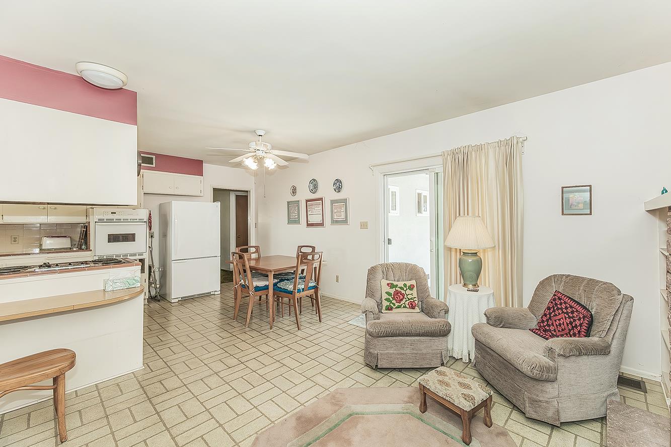 1416 South Church Avenue Reedley, CA 93654 - Photo 11 of 41 a living room with furniture and a dining table with kitchen appliances