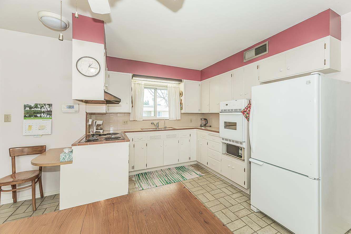 1416 South Church Avenue Reedley, CA 93654 - Photo 17 of 41 a kitchen with white cabinets and white appliances