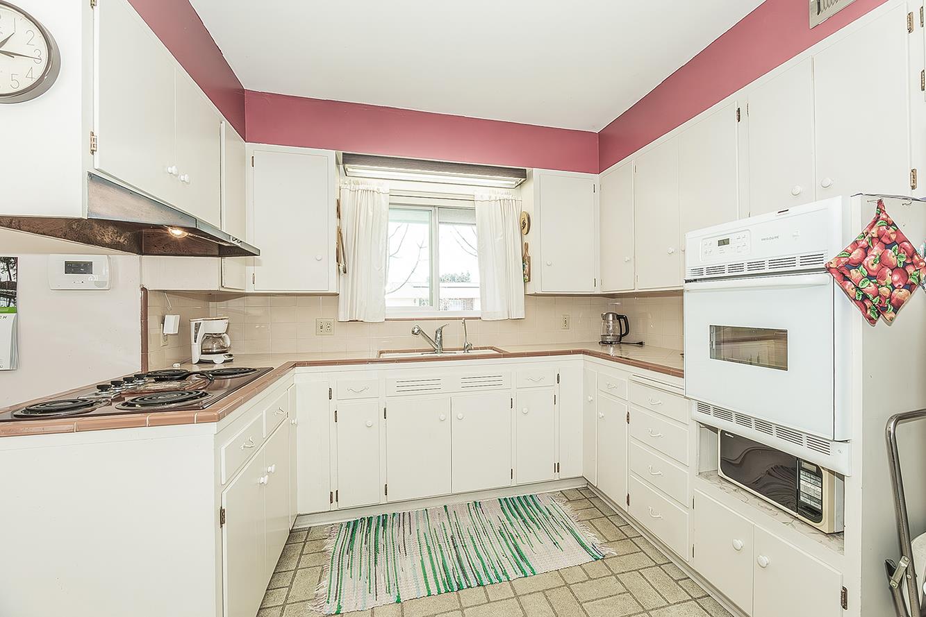 1416 South Church Avenue Reedley, CA 93654 - Photo 18 of 41 a kitchen with granite countertop a white stove top oven sink and cabinets