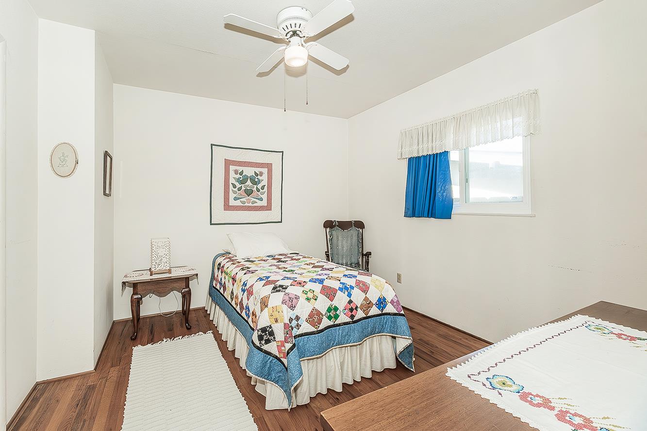 1416 South Church Avenue Reedley, CA 93654 - Photo 22 of 41 a bedroom with a bed and a table in it