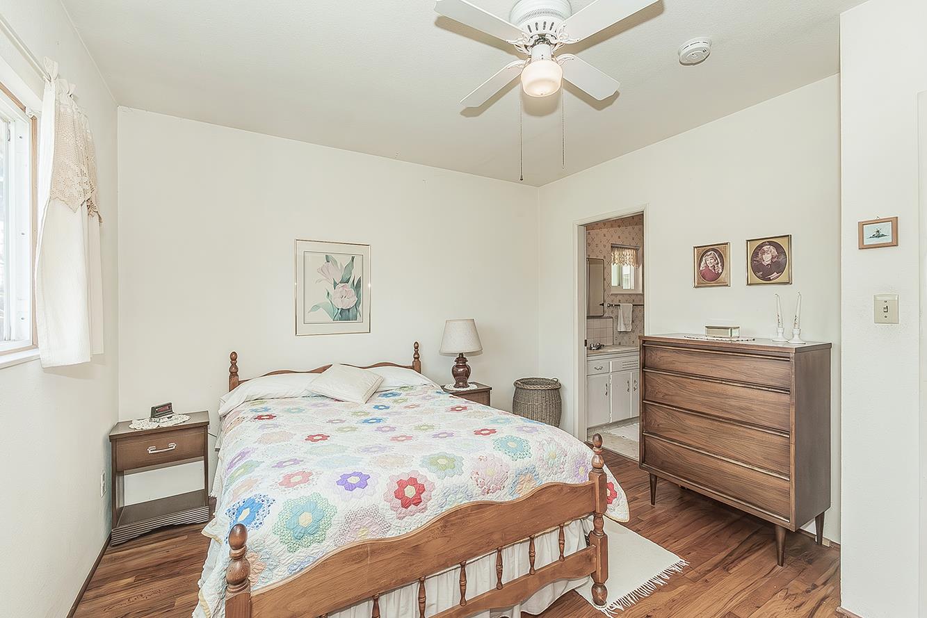 1416 South Church Avenue Reedley, CA 93654 - Photo 23 of 41 a bedroom with a bed and a chandelier