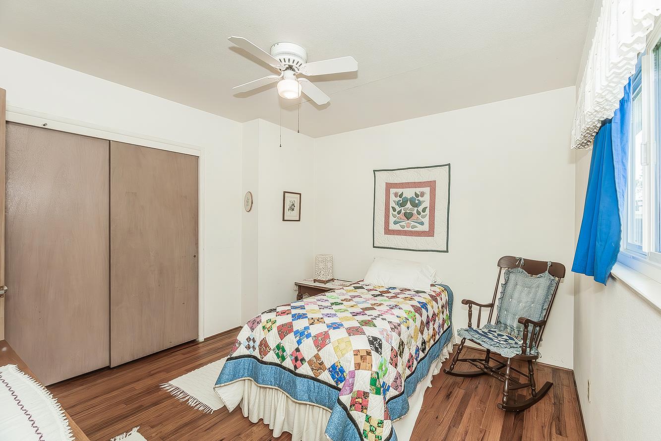 1416 South Church Avenue Reedley, CA 93654 - Photo 23 of 41 a bedroom with a bed and a chandelier