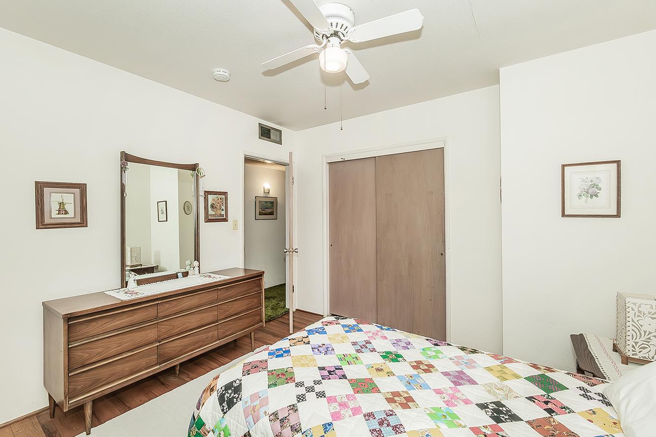 1416 South Church Avenue Reedley, CA 93654 - Photo 24 of 41 a bedroom with a bed and a chandelier
