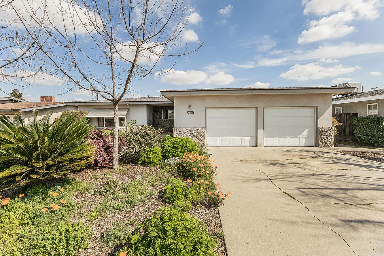 1416 South Church Avenue Reedley, CA 93654 - Photo 3 of 41 a front view of a house with a garden