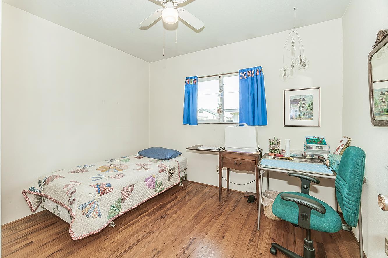 1416 South Church Avenue Reedley, CA 93654 - Photo 31 of 41 a bedroom with a bed and a table in it